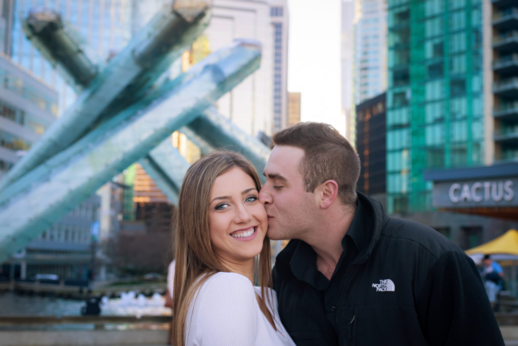 Couple at Olympic cauldron in Vancouver kissing 